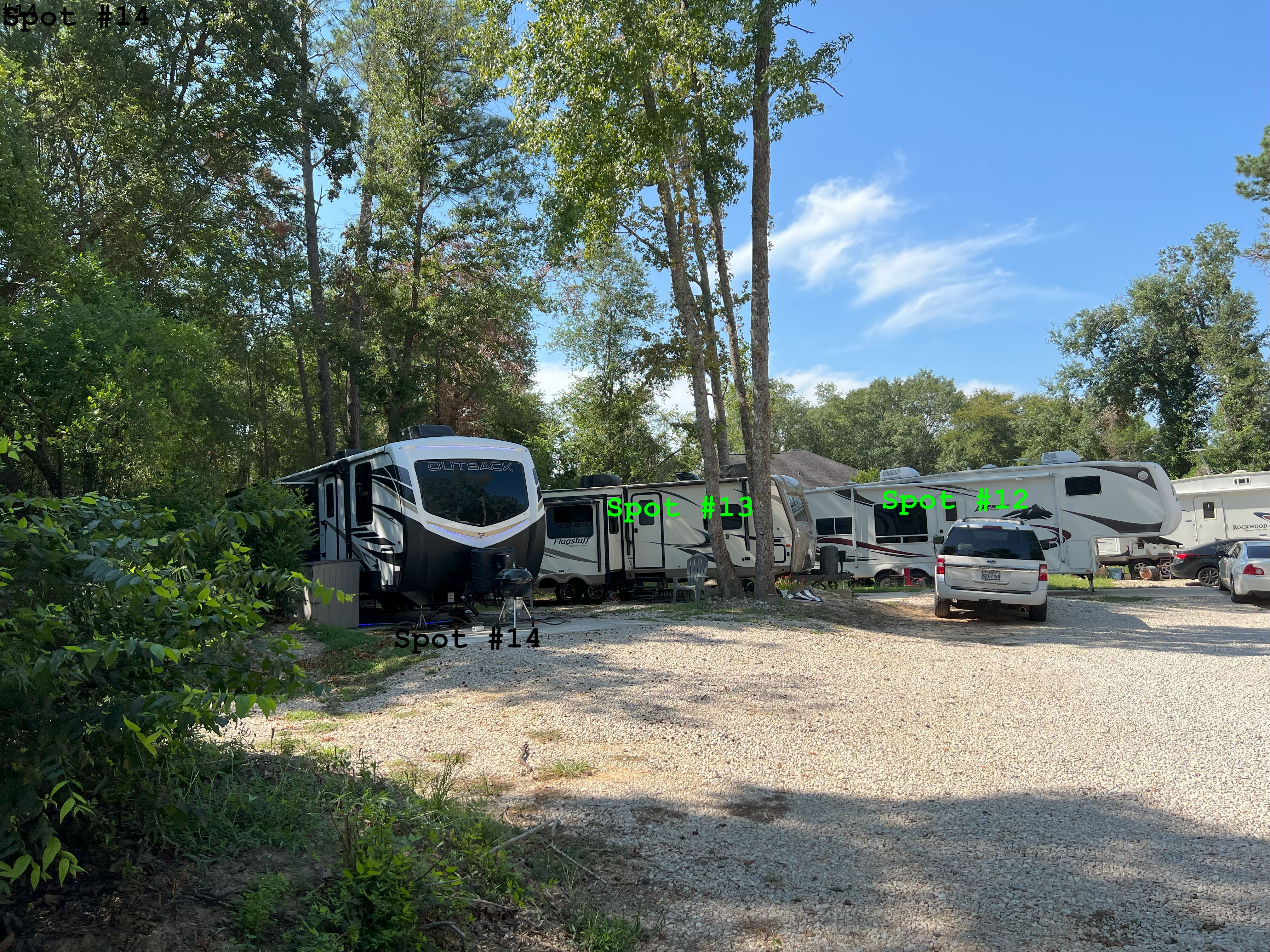 RV spots 12, 13, and 14 in a quiet corner of the park, shown in a calm, peaceful setting with full hookups and clean pads