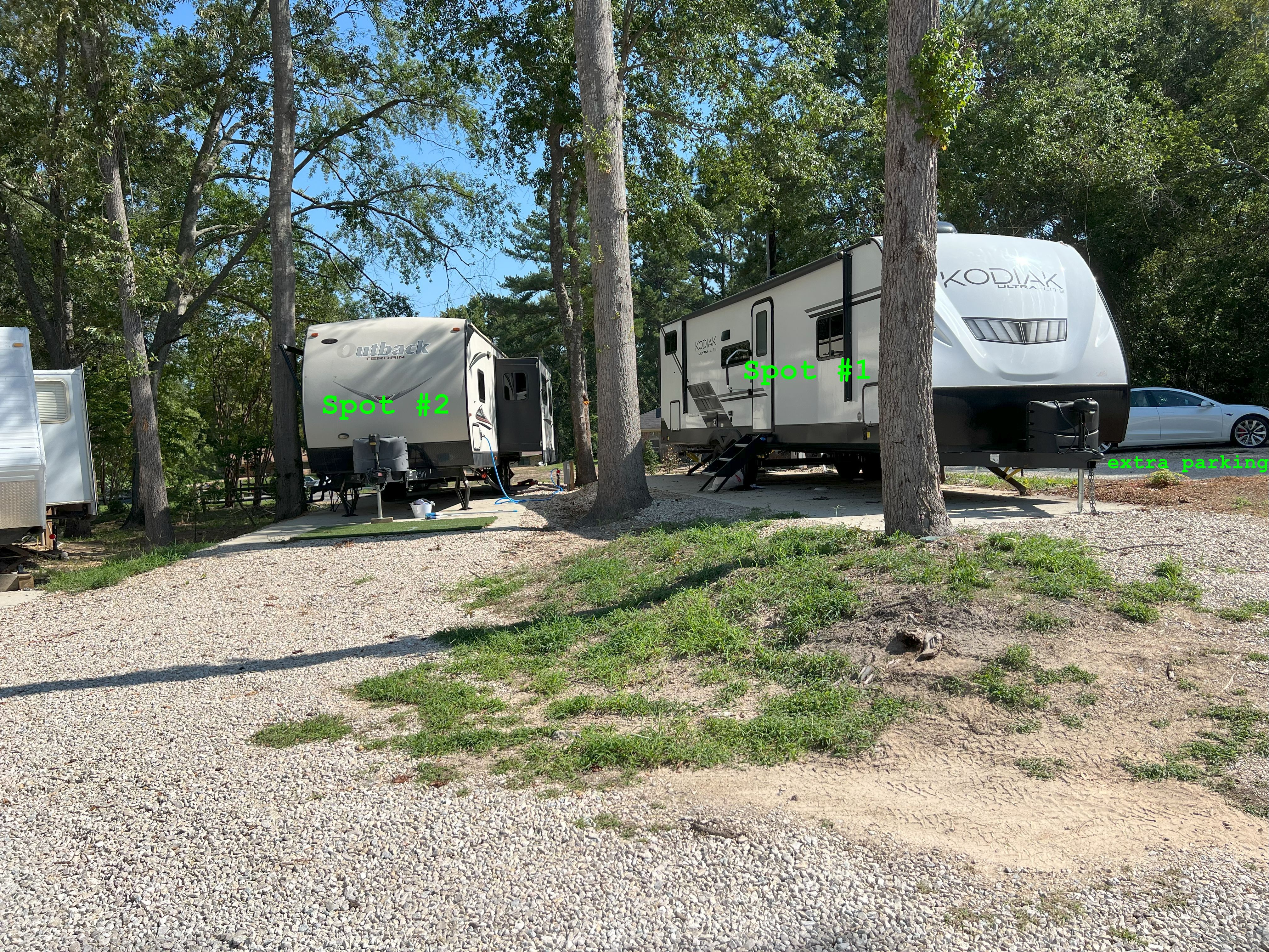 RV spots 1 and 2 with concrete pads, full hookups, and an additional parking space beside the sites