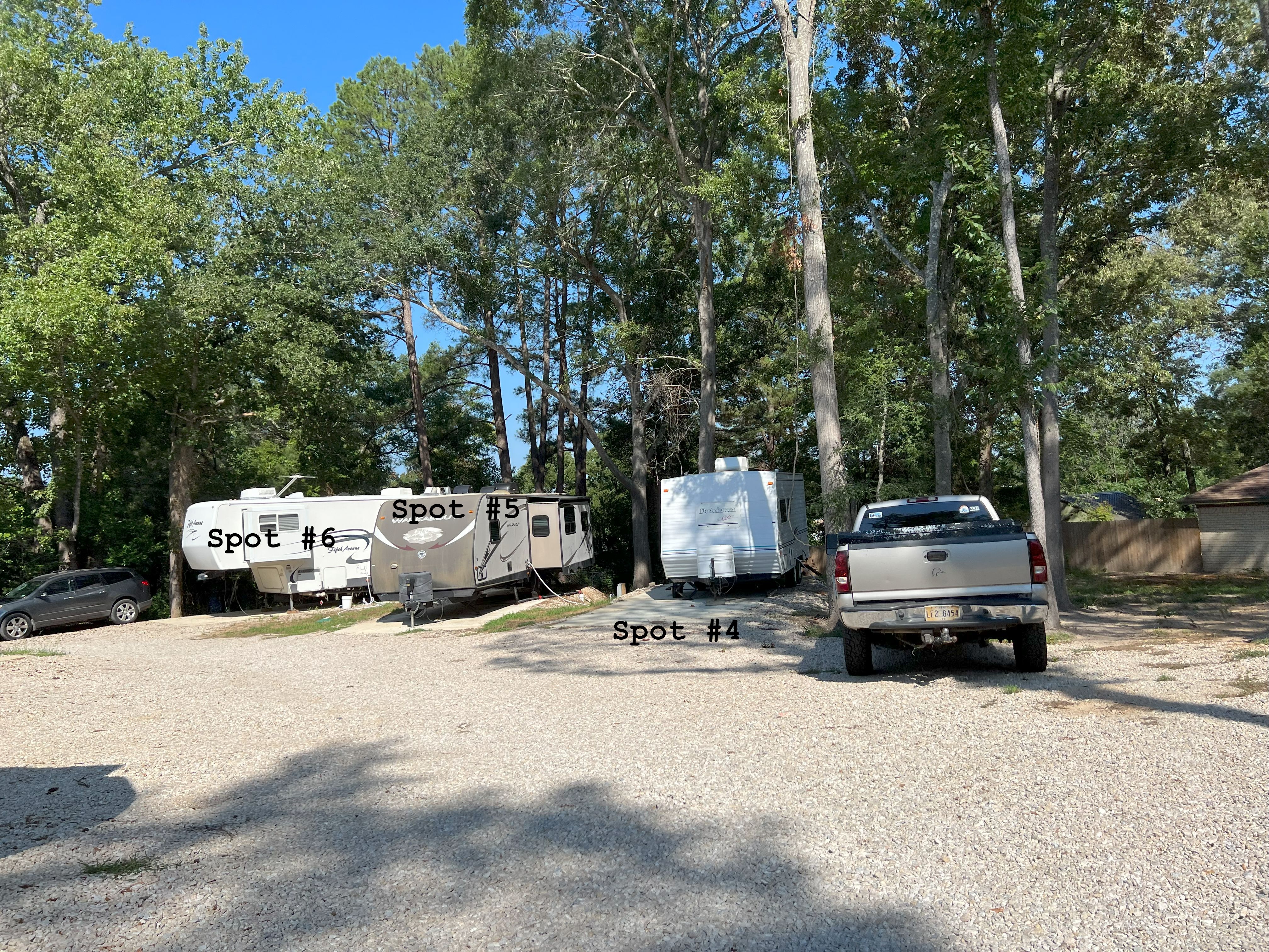 RV spots 4, 5, and 6 with full hookups, shaded pads, and a grassy walking area behind the sites