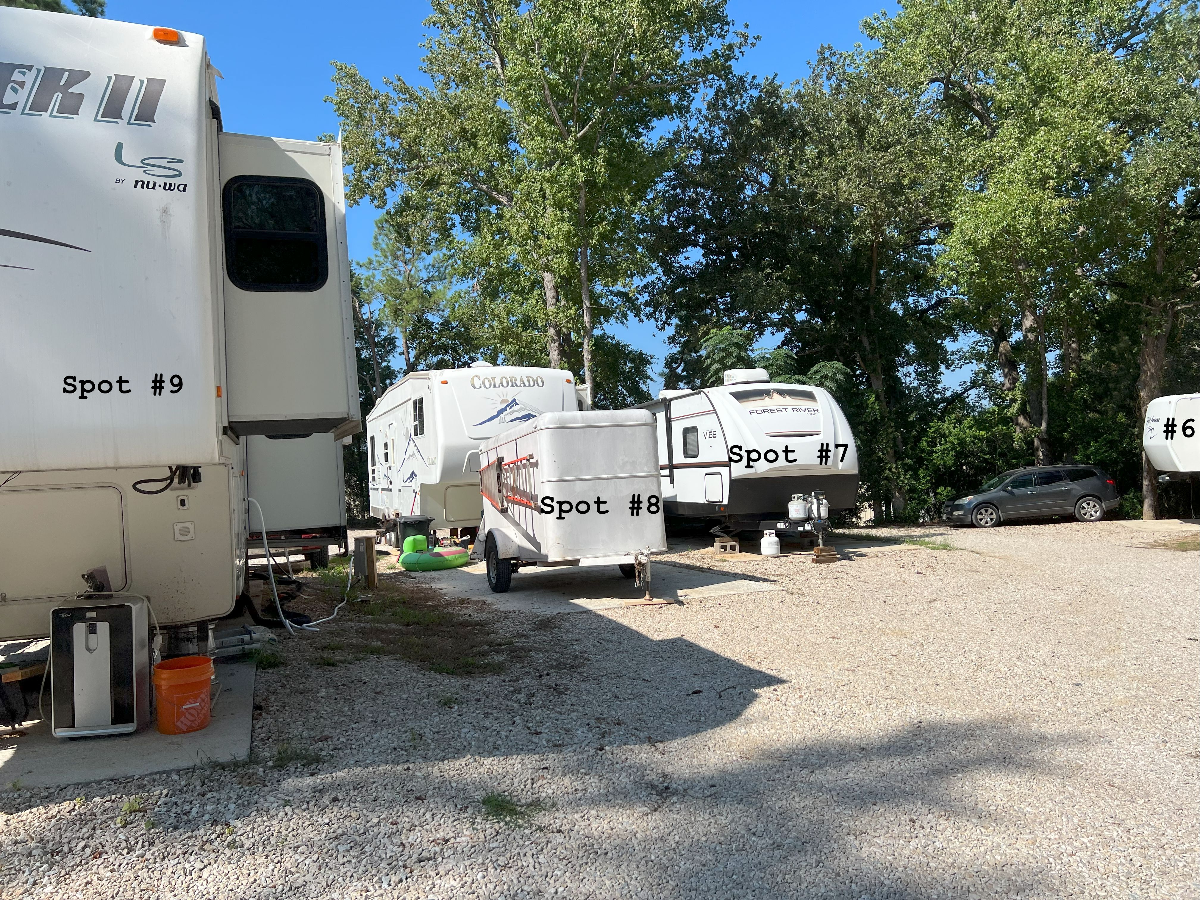 RV spots 6 through 9 shown clean and well-spaced, each with concrete pads and full 50/30 amp hookups