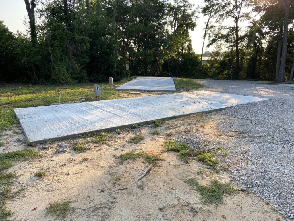 RV spot 11 with 50/30 amp hookups, sewer, and water on 12x30 concrete pad