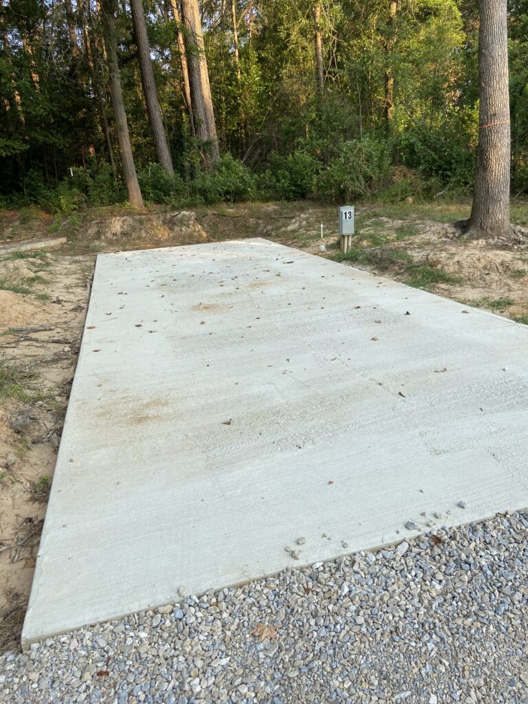 RV spot 13 with 50/30 amp hookups, sewer, and water on 12x35 concrete pad