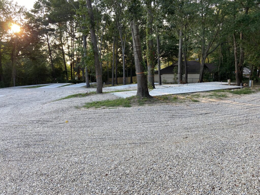 RV spots 1 to 6 near the main entrance, north-facing and fully shaded by mature trees with concrete pads and full hookups