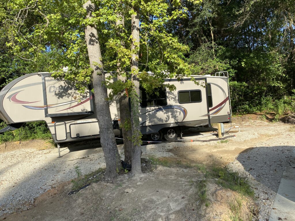 RV spot 14 with 50/30 amp hookups, sewer, and water on 12x40 concrete pad