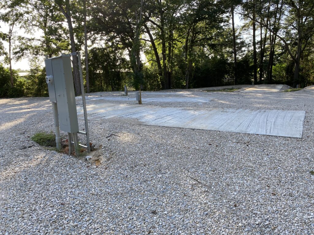 RV spot 9 with 50/30 amp hookups, sewer, and water on 12x30 concrete pad
